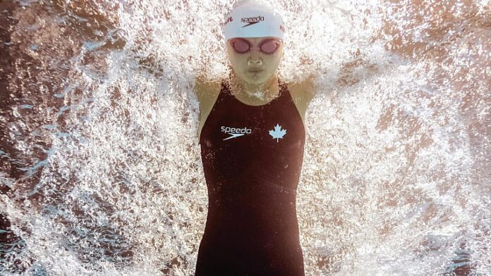 Breaking News: Olympic swimmer Maggie Mac Neil will arrive in Tokyo with a bang. Three, in fact.